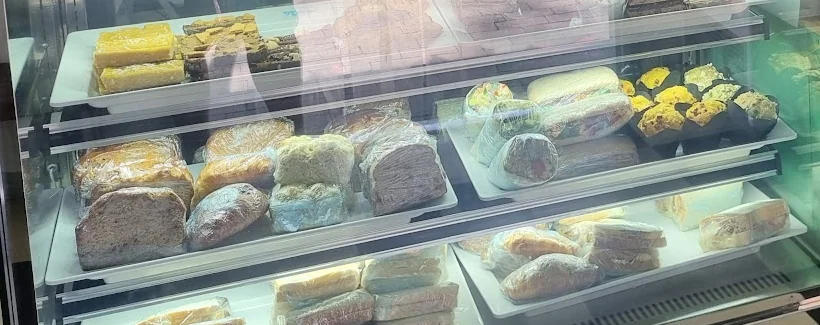 Breads, rolls and baked treats in the café cabinet