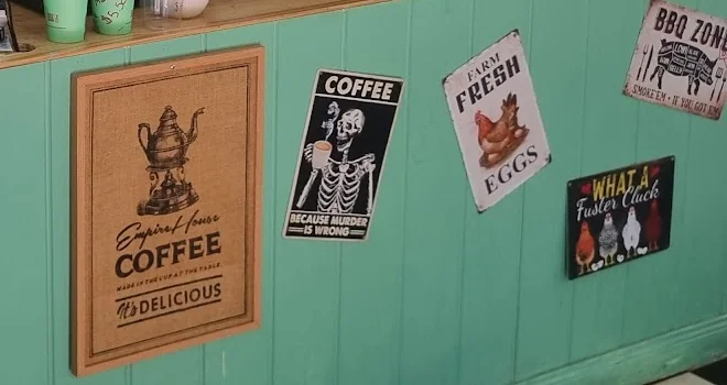 The café’s blue-green timber counter and vintage coffee sign